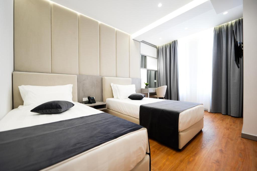 Postel nebo postele na pokoji v ubytování Naos Luxury Hotel