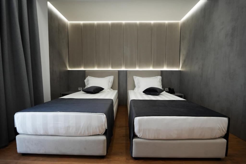 Postel nebo postele na pokoji v ubytování Naos Luxury Hotel