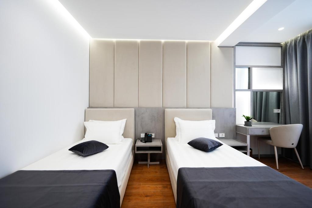 Postel nebo postele na pokoji v ubytování Naos Luxury Hotel
