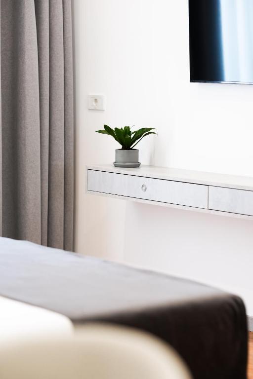 Postel nebo postele na pokoji v ubytování Naos Luxury Hotel