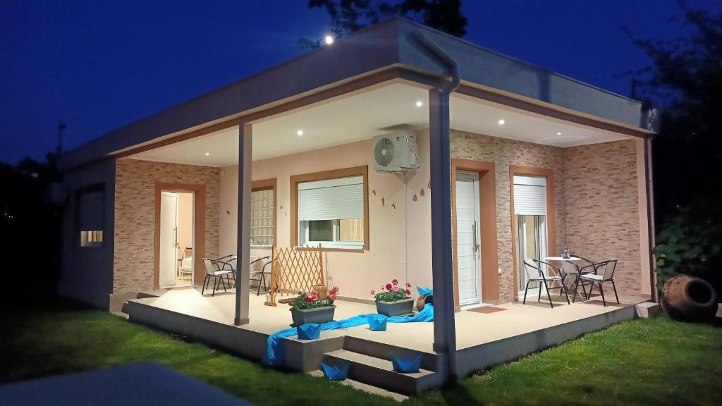 a home with a gazebo in the yard at night at Bright Sea - Studios in Limenas