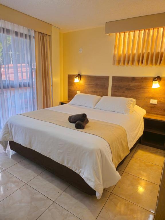 Postel nebo postele na pokoji v ubytování Hotel Tungurahua