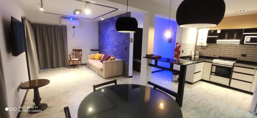 a kitchen and living room with a table in a room at Complejo las Catalinas Dto 2 A in Puerto Madryn