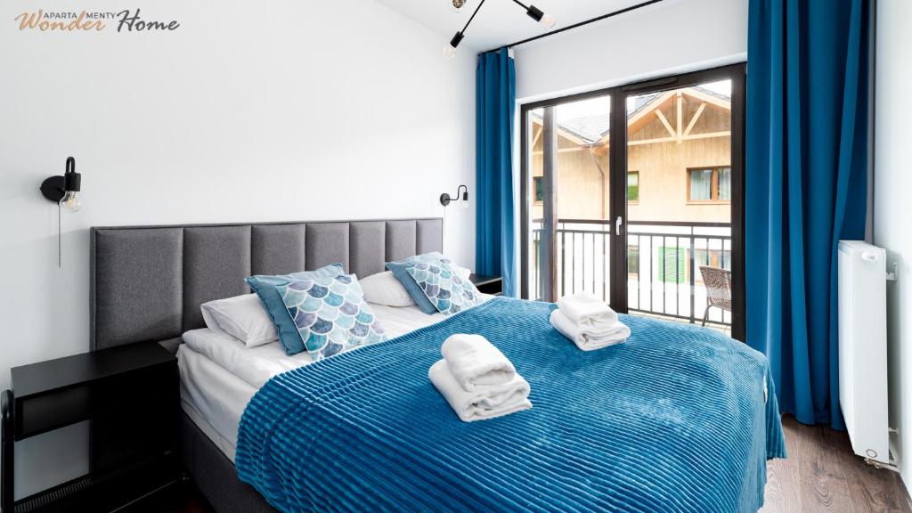 Posteľ alebo postele v izbe v ubytovaní Wonder Home - Apartamenty Karpatia Resort tuż przy stoku i blisko szlaków turystycznych