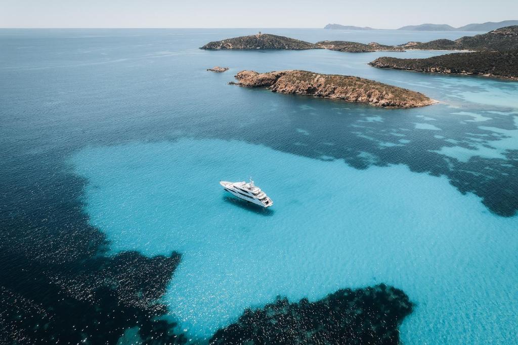 an aerial view of a boat in the water at Villa Perdalonga, Vista Mare Sea View Tuerredda in Teulada