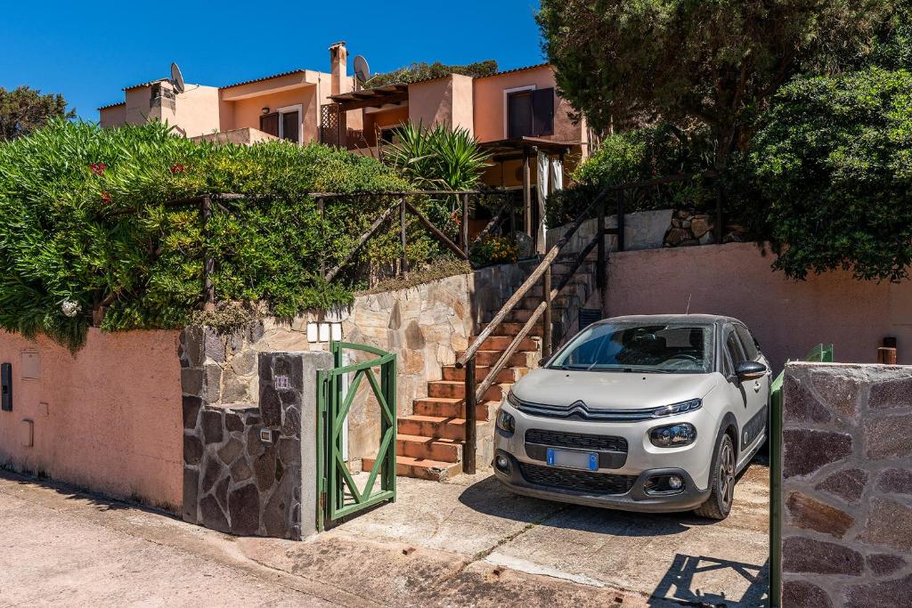 a white car parked next to a building at Villa Perdalonga, Vista Mare Sea View Tuerredda in Teulada
