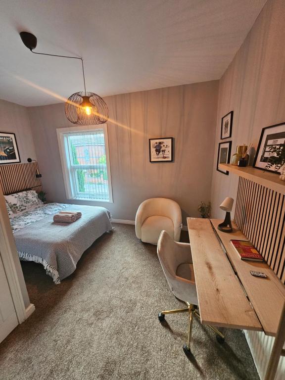 a bedroom with a bed and a desk with a chair at Hillsome Hosting Wigan in Pemberton