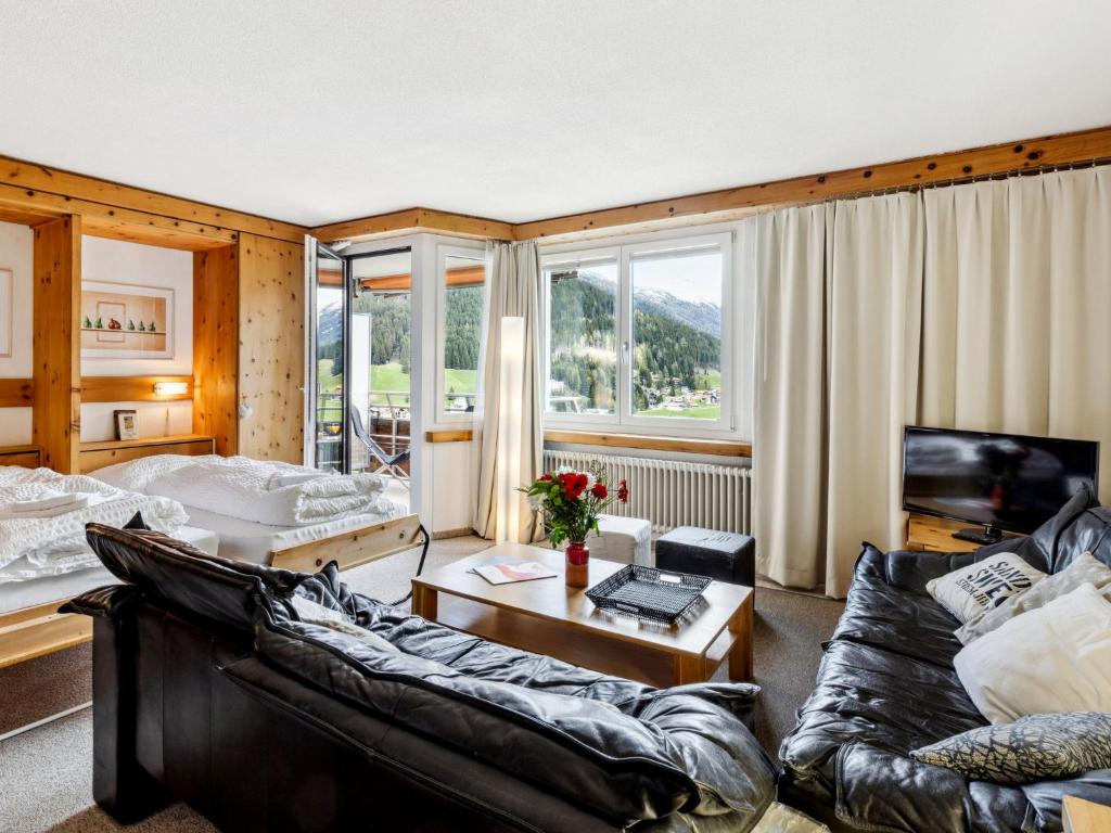 a living room with a couch and a table at Apartment Guardaval Apt 308 by Interhome in Davos