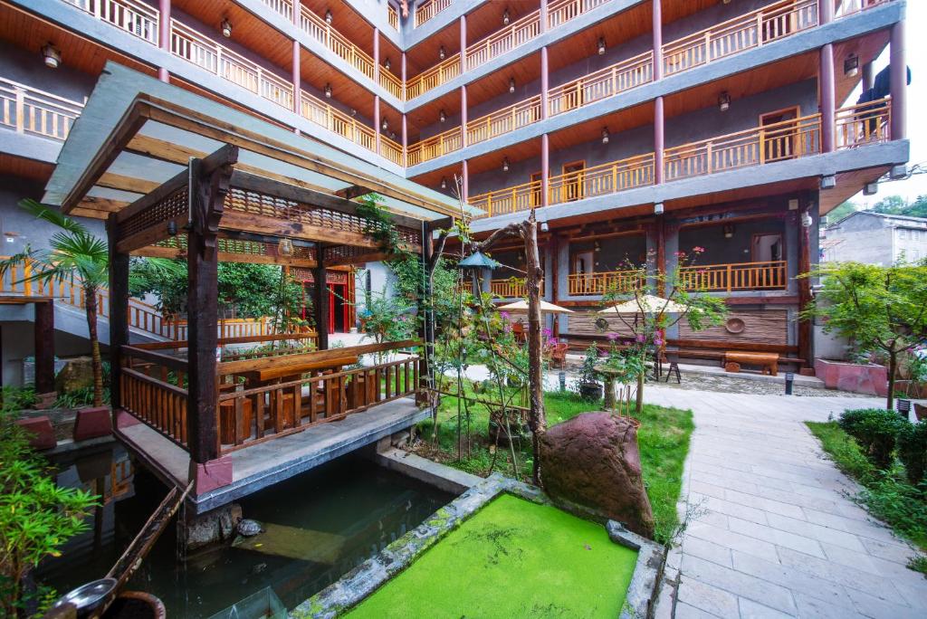 an external view of a building with a pool of water at Hongfu Villa - Zhangjiajie National Forest Park West Gate in Zhangjiajie
