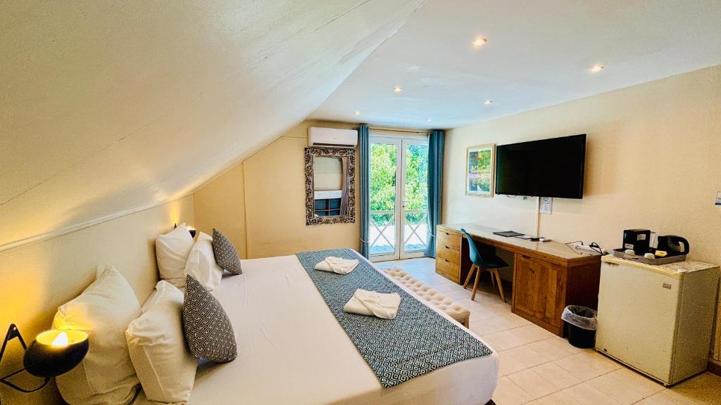 Postel nebo postele na pokoji v ubytování Hôtel Coco Island