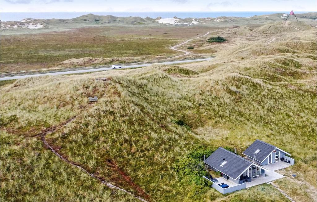 an aerial view of a house in a field at Holiday Home Sdr Klitvej Hvide Sande Denm in Havrvig