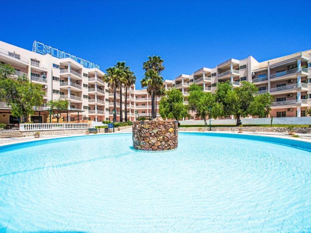 a large swimming pool in front of a large apartment building at Apartment Estrela do Vau Apart- 3 bedroom-3 by Interhome in Portimão