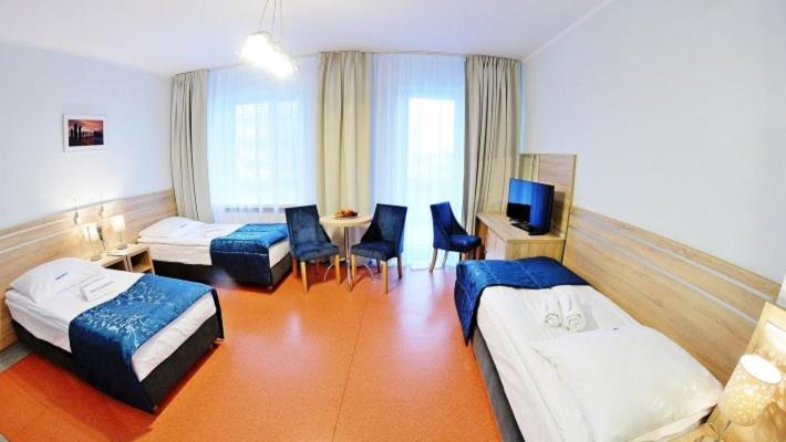 Posteľ alebo postele v izbe v ubytovaní Sanatorium Muszelka