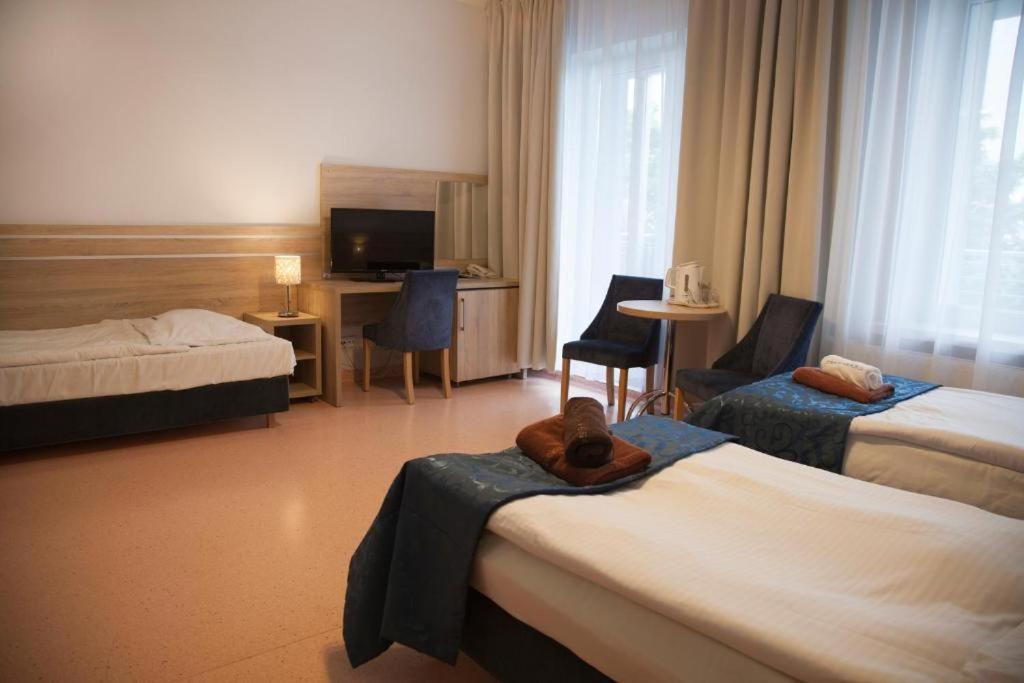 Posteľ alebo postele v izbe v ubytovaní Sanatorium Muszelka