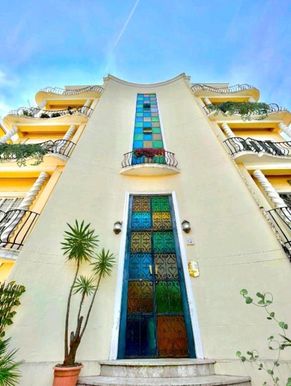 a building with colorful stained glass windows on it at C 'est la Vie in Lido di Ostia