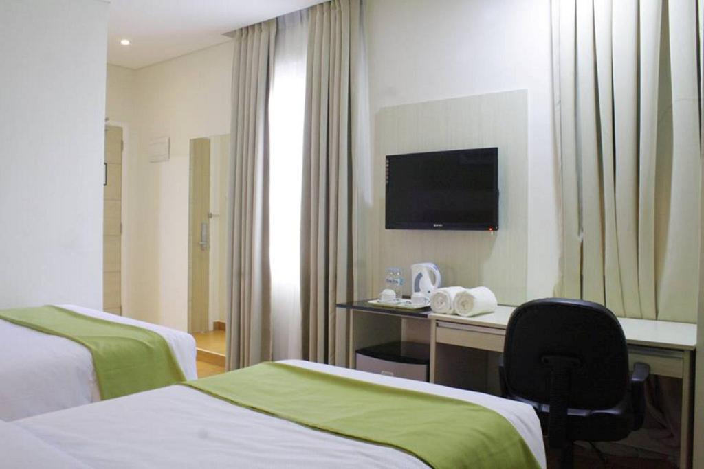 Postel nebo postele na pokoji v ubytování Hamersons Hotel Cebu