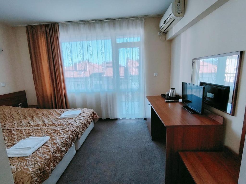 Postel nebo postele na pokoji v ubytování Sandor Hotel
