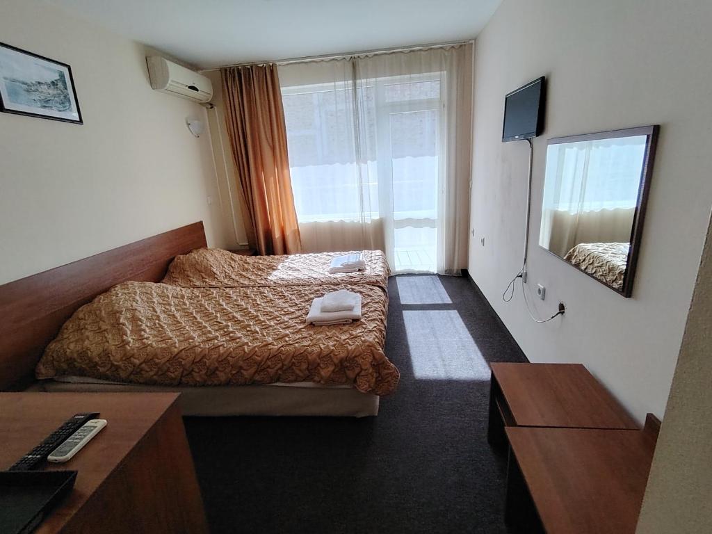 Postel nebo postele na pokoji v ubytování Sandor Hotel