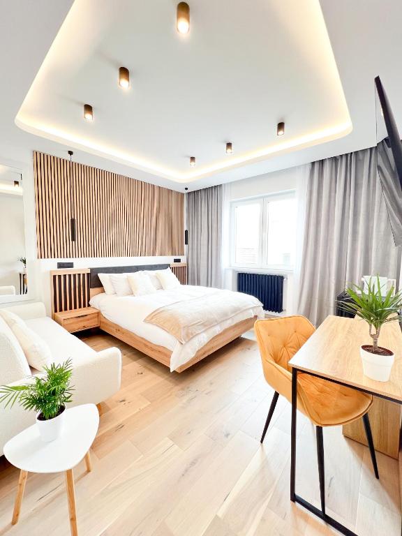 a bedroom with two beds and a table and chairs at Milan Boutique Villa in Paderno Dugnano