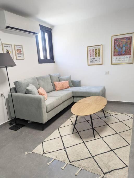 a living room with a couch and a table at Benemanuel Oasis in Beer Sheva