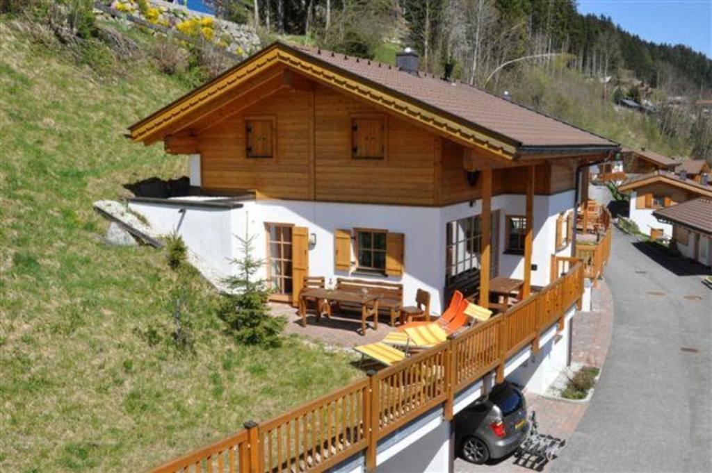a large house with a porch and a balcony at Schöneben Chalet Holzblick in Wald im Pinzgau