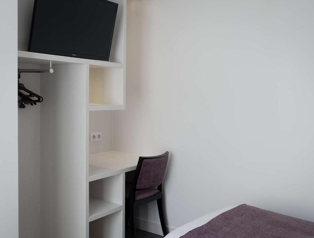 TV a/nebo společenská místnost v ubytování Brit Hotel de Grignan Vichy