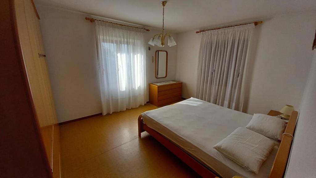 Ένα ή περισσότερα κρεβάτια σε δωμάτιο στο Casa Valle Folgaria
