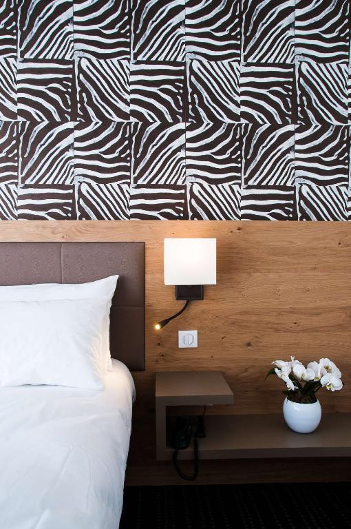 Postel nebo postele na pokoji v ubytování Le Lodge Brit Hotel Strasbourg Zenith
