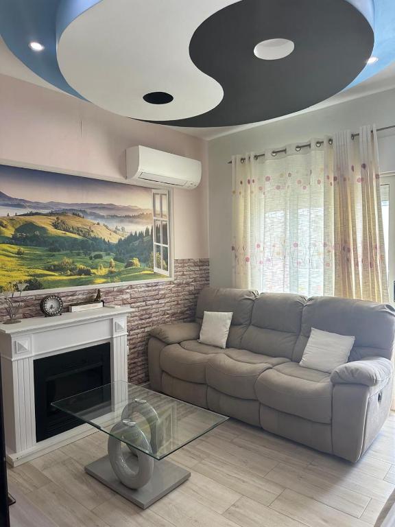 a living room with a couch and a fireplace at YOUR PERFECT SEASIDE Apartment in Draç