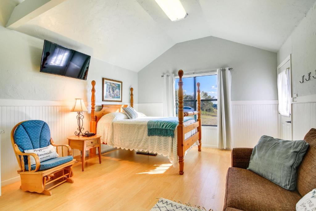 a bedroom with a bed and a tv and a couch at Ranch Cabin with Decks, 10 Mi to Fredericksburg in Fredericksburg