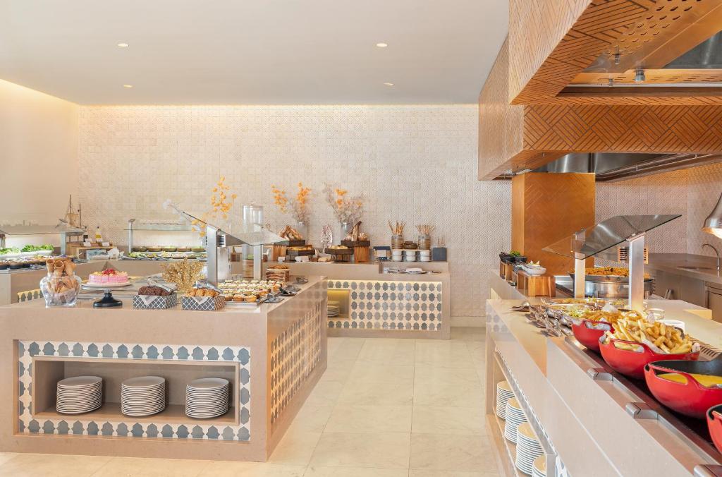 a large kitchen with a buffet in a restaurant at Desire Riviera Maya Resort All Inclusive - Couples Only in Puerto Morelos