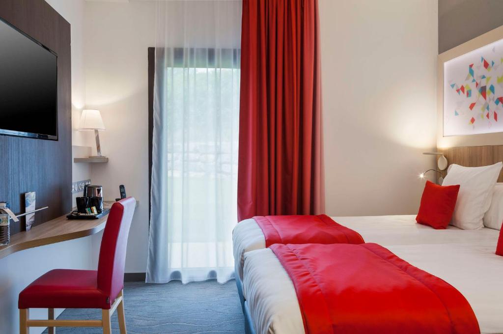 Postel nebo postele na pokoji v ubytování Brit Hotel Privilège Figeac