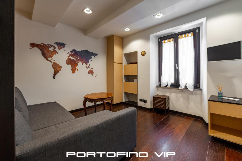 a living room with a couch and a world map on the wall at Da I Gemelli Loft by PortofinoVip in Portofino