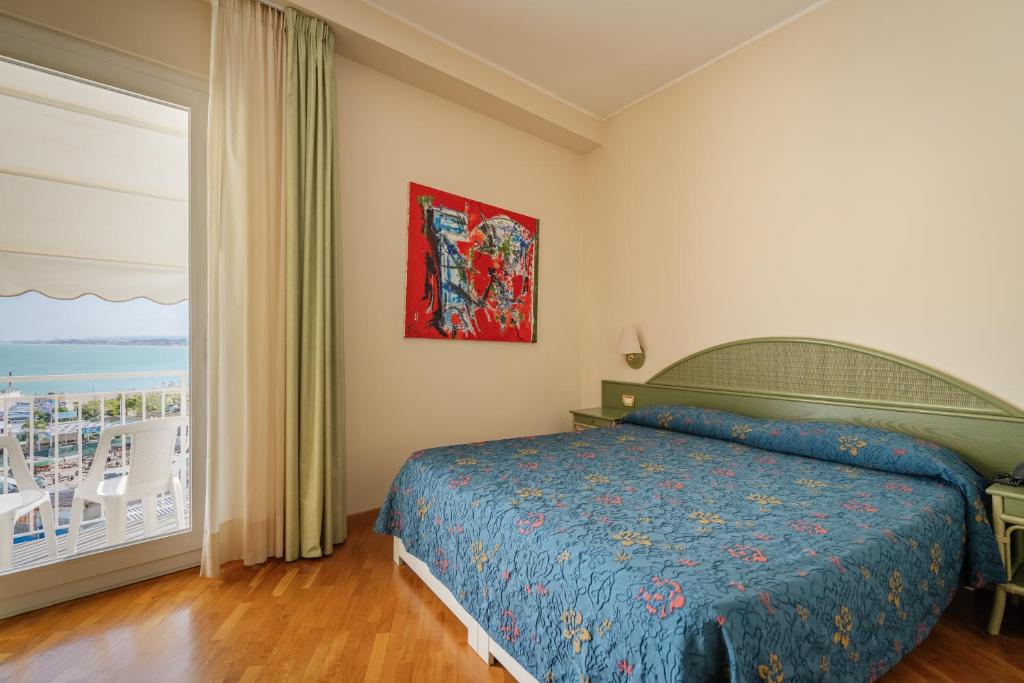 Postel nebo postele na pokoji v ubytování Hotel Scogliera