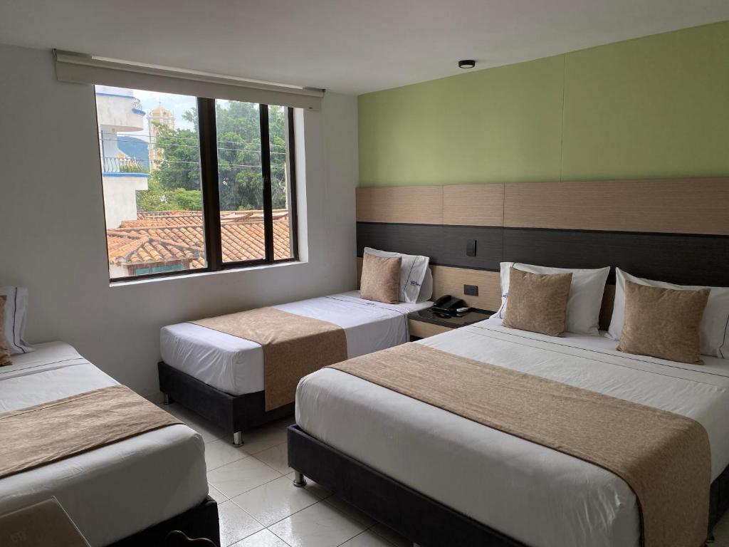 Postel nebo postele na pokoji v ubytování Hotel Plaza Real Ocaña