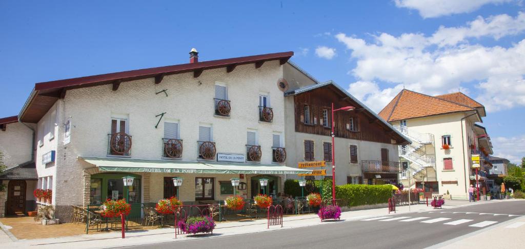 a building on the corner of a street in a town at Hôtel de la Poste in Malbuisson