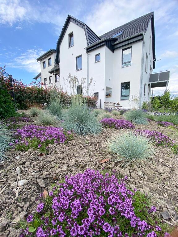 a house with purple flowers in front of it at Apartmenthaus Bella Casa in Hagen