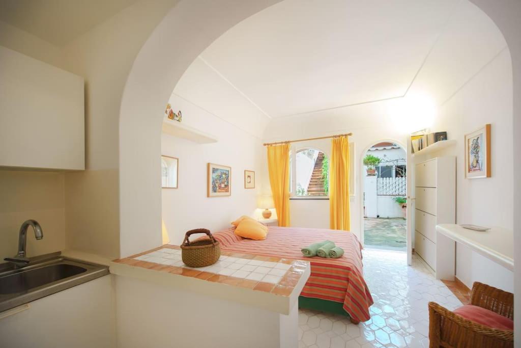 a bedroom with a bed and a sink at La Piccola, Capri in Capri