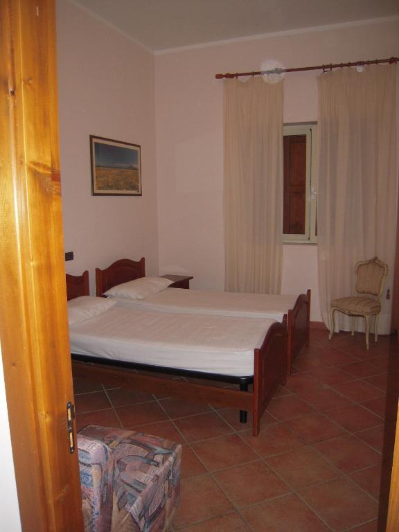 Łóżko lub łóżka w pokoju w obiekcie Agriturismo il Contadino