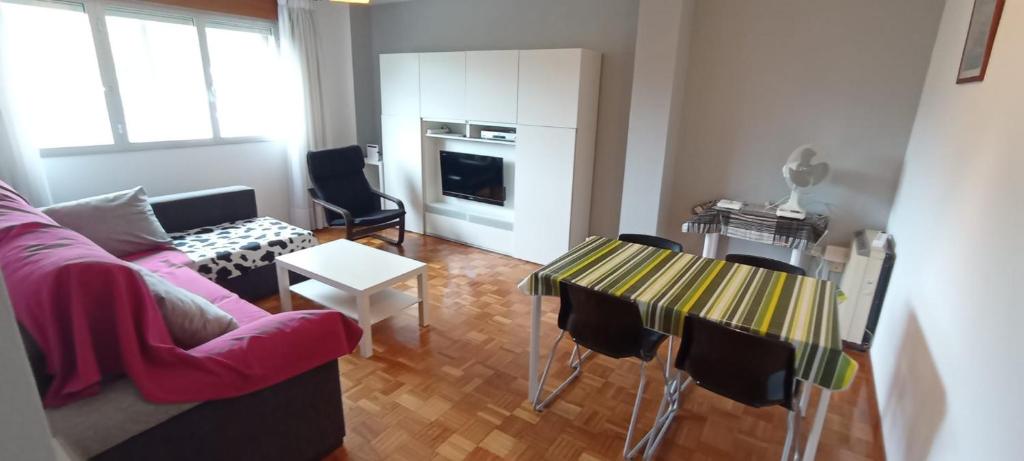 a living room with a couch and a table at EnVIVEIRO Destino Playa de Covas in Viveiro
