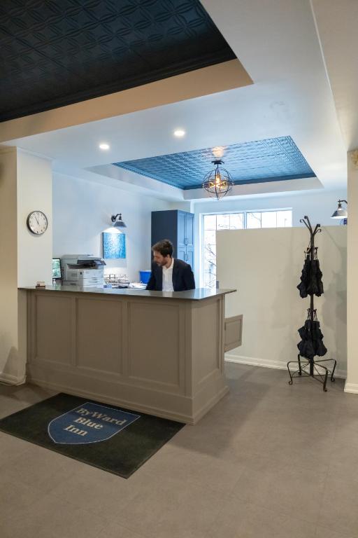 a woman standing at a counter in an office at ByWard Blue Inn in Ottawa