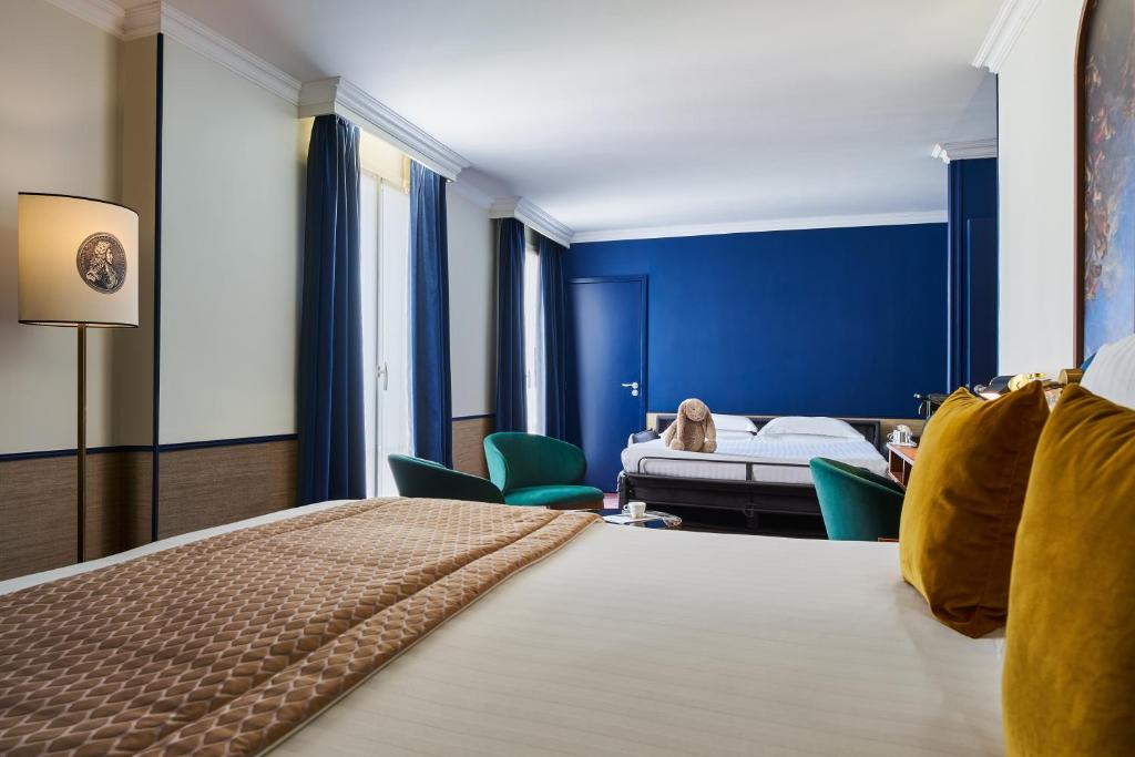 Un ou plusieurs lits dans un hébergement de l'établissement Hôtel Le Versailles