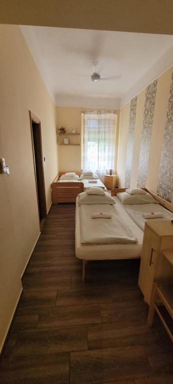 Łóżko lub łóżka w pokoju w obiekcie Megyeház Apartman