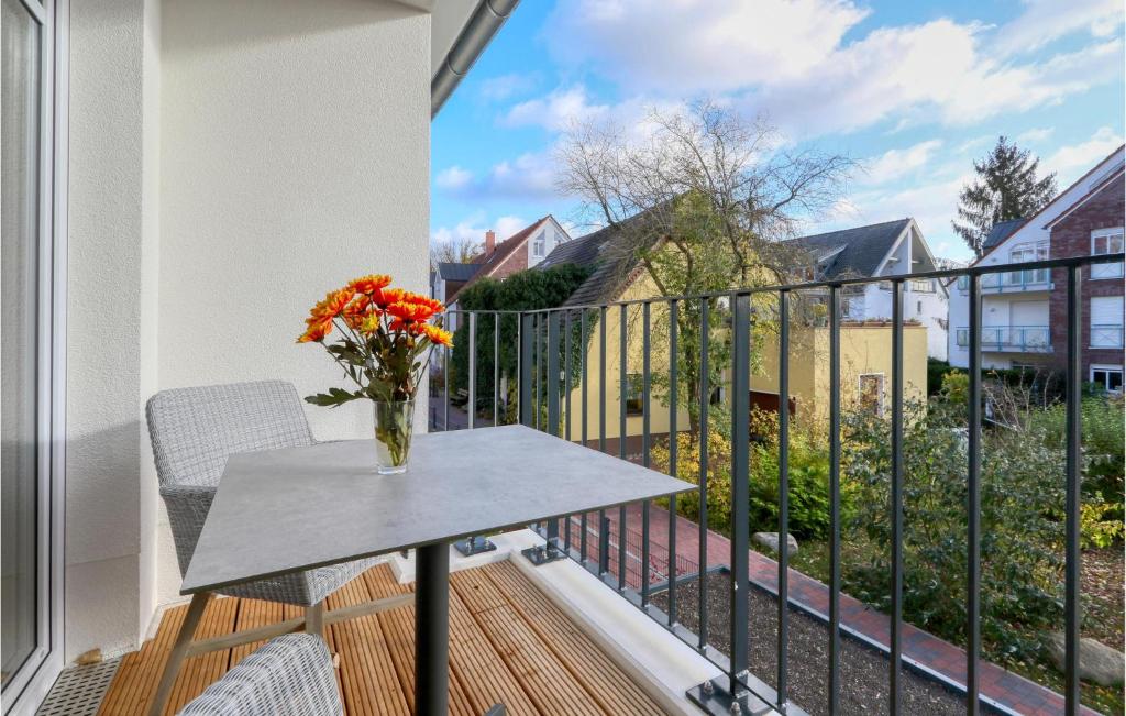 a vase of flowers on a table on a balcony at Baltischer Hof Apartment 26 in Boltenhagen