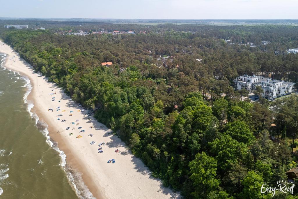 an aerial view of a beach with a group of people at Sunset A23 przy plaży in Pobierowo