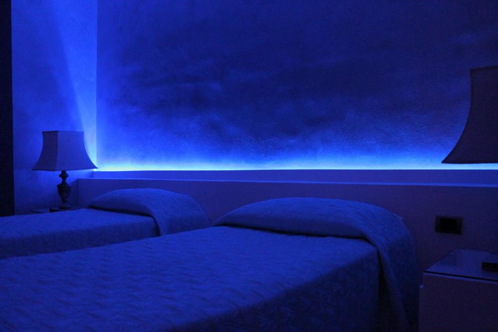 Postel nebo postele na pokoji v ubytování Hotel Parco dei Principi