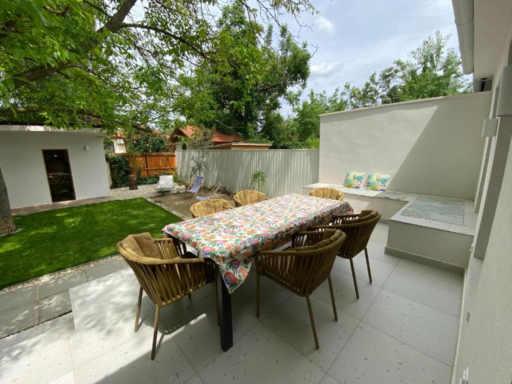 a patio with a table and chairs on a patio at Bánhiday H31 Beach house in Balatonakarattya