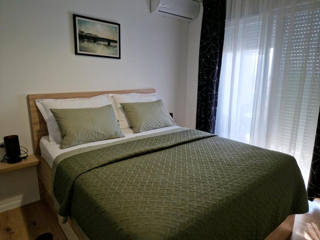 Postel nebo postele na pokoji v ubytování Apartman Metković City