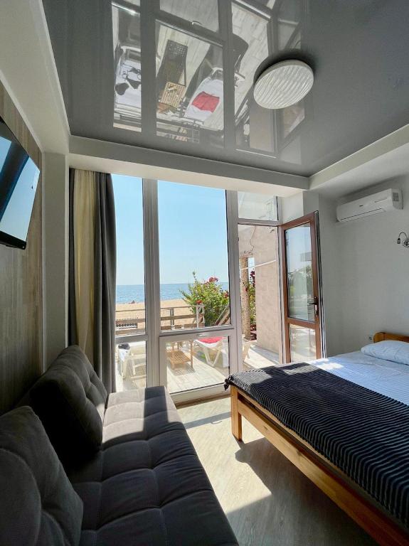 a bedroom with a bed and a view of the ocean at Volna in Odesa