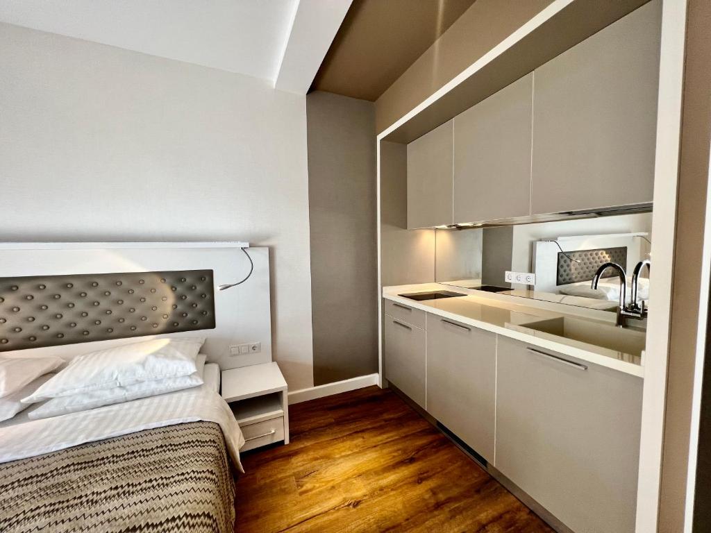 a small apartment with a bed and a kitchen at Sunshine Apartments Batumi in Batumi